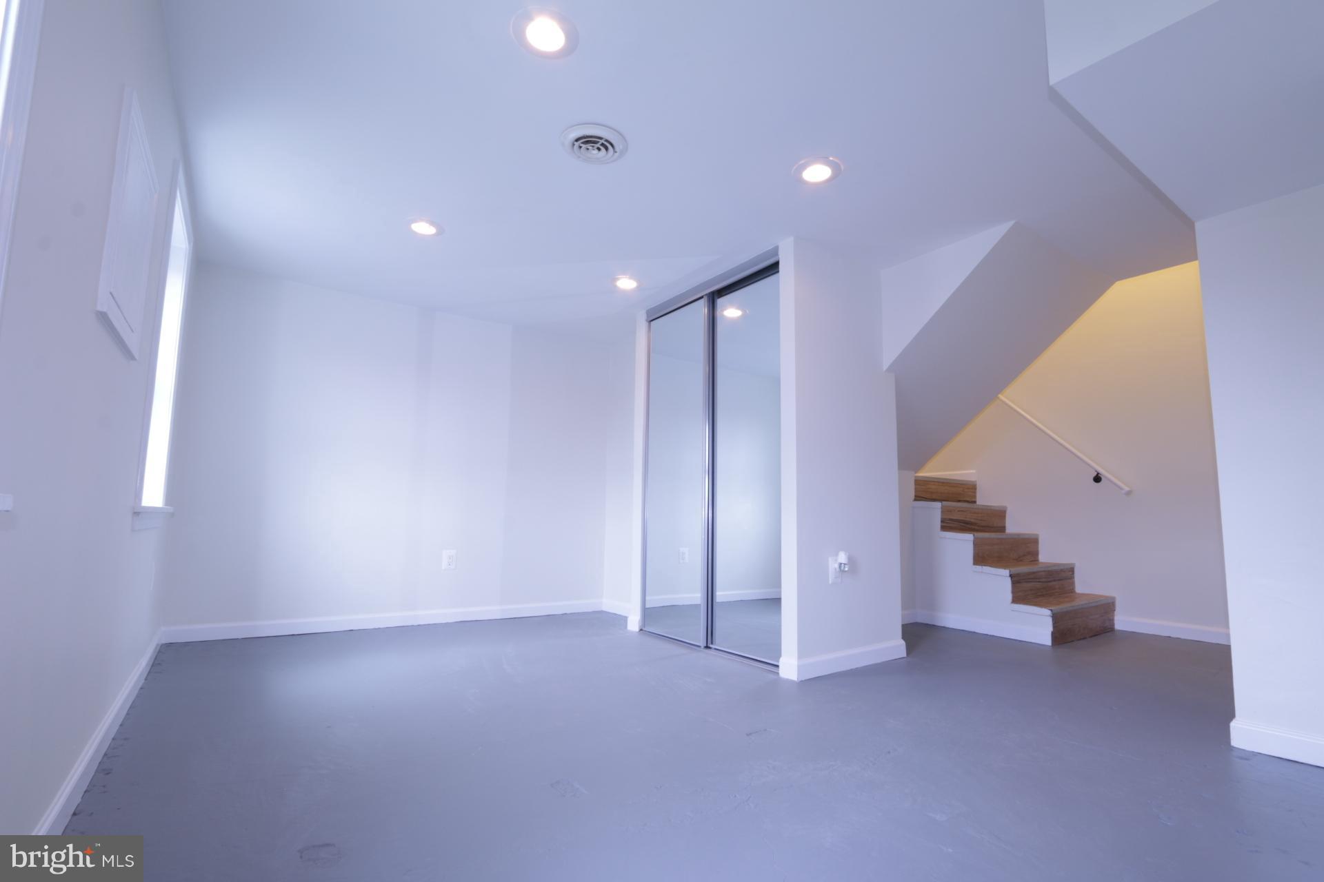 3723 South Kemper Road Arlington, VA 22206 - Photo 6 of 15 an empty room with staircase and white walls