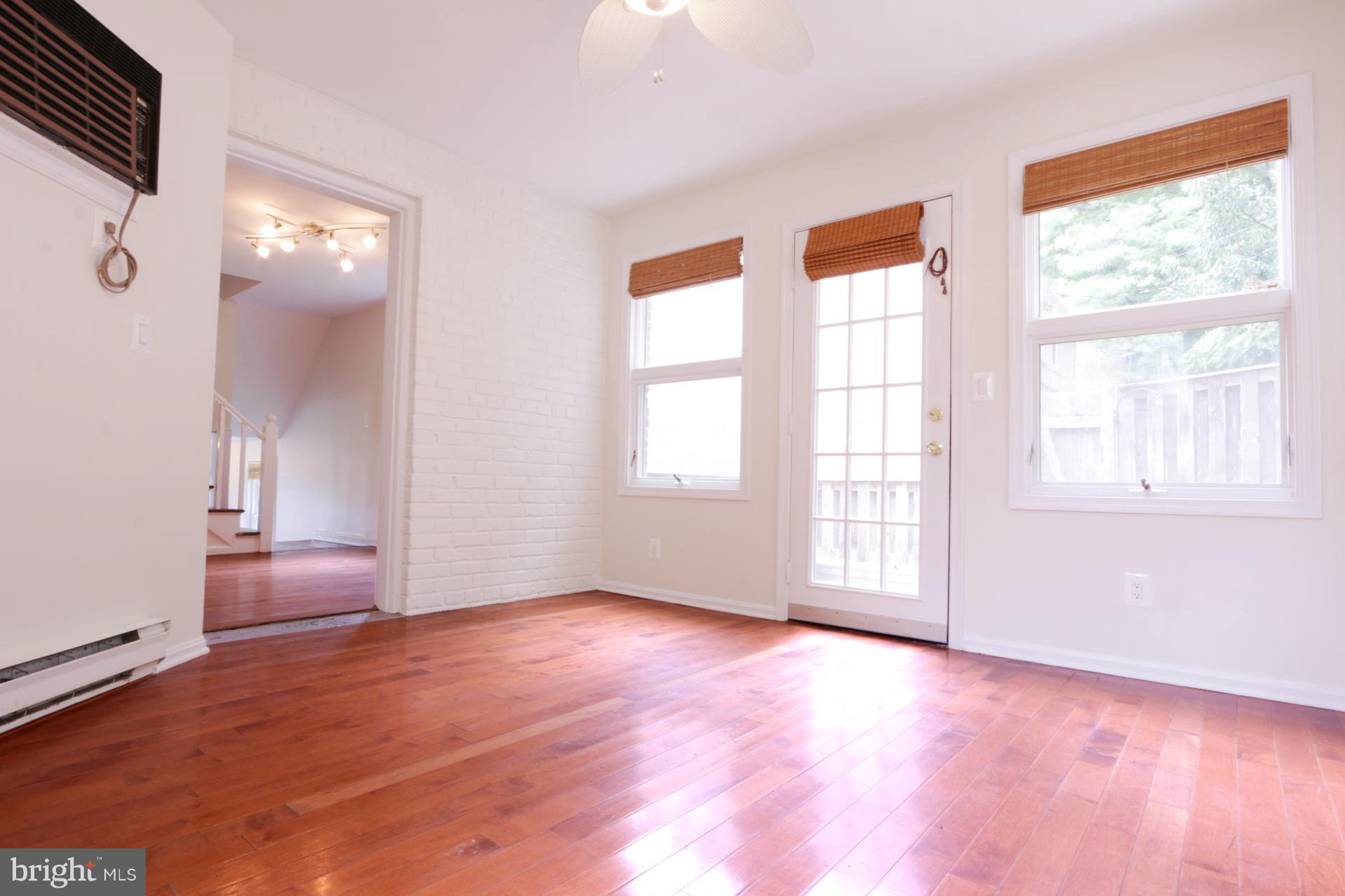 3723 South Kemper Road Arlington, VA 22206 - Photo 9 of 15 an empty room with wooden floor and windows