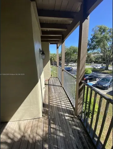 a view of balcony with wooden floor