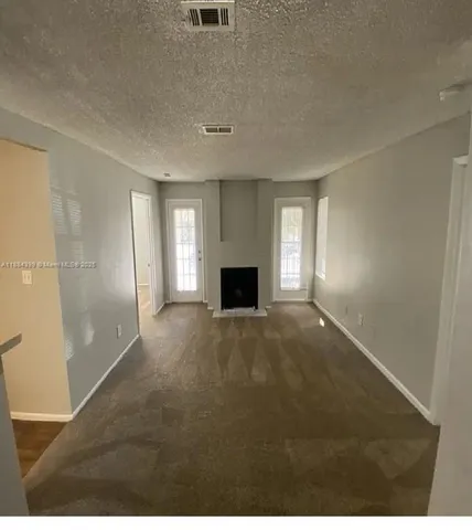 a view of empty room with a fireplace