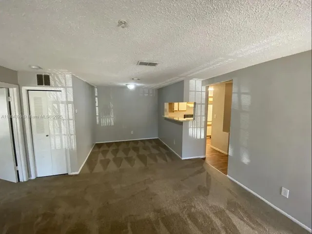 a view of a big room with windows and cabinet