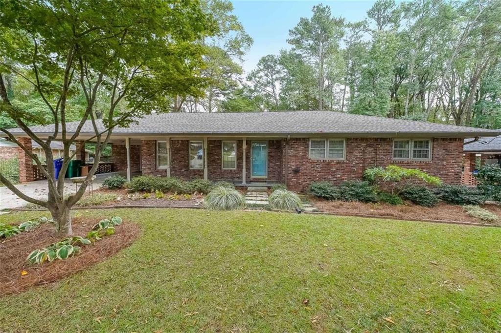 a view of a house with backyard and sitting area