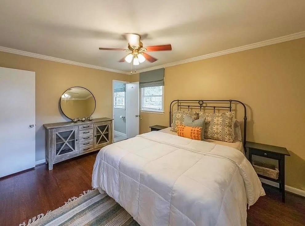 1445 Linkwood Lane Decatur, GA 30033 - Photo 16 of 30 a bedroom with a bed a mirror on dresser and a chandelier