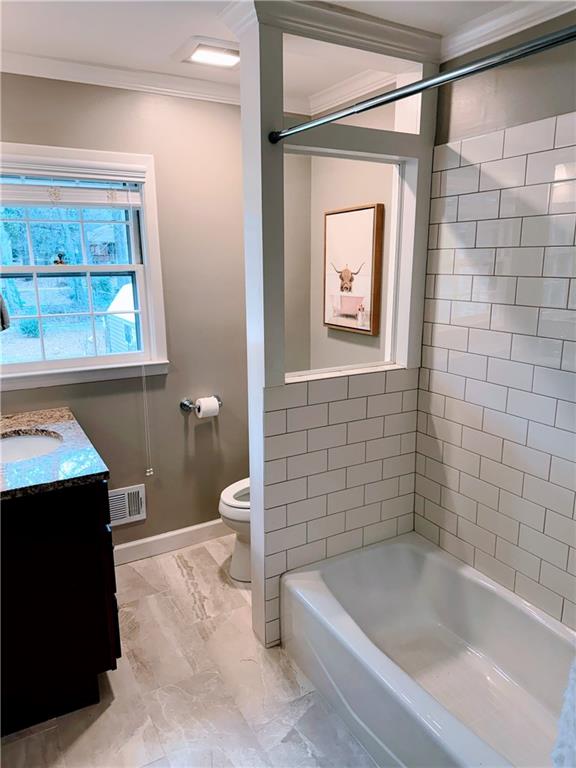 1445 Linkwood Lane Decatur, GA 30033 - Photo 17 of 30 a bathroom with a bathtub and a window