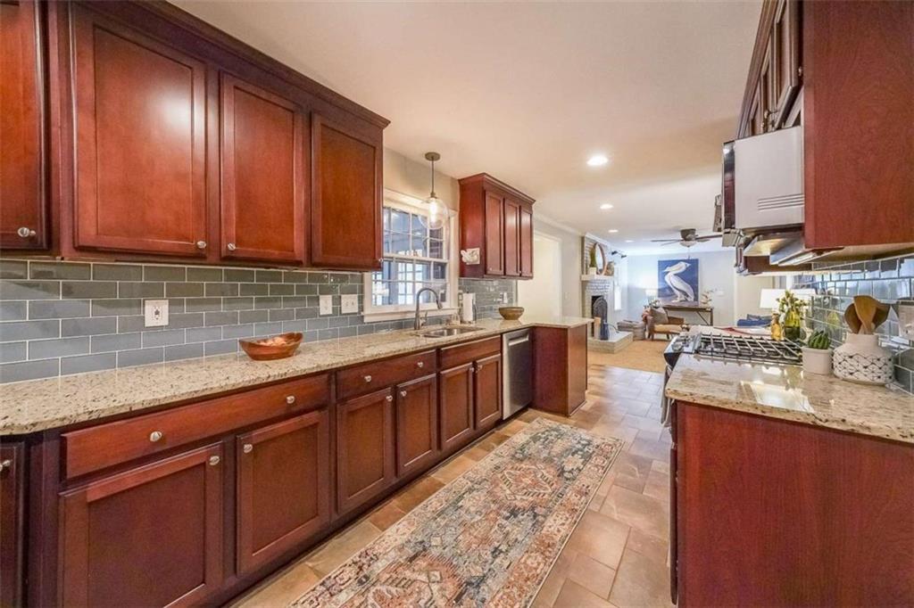 1445 Linkwood Lane Decatur, GA 30033 - Photo 9 of 30 a kitchen with stainless steel appliances granite countertop wooden cabinets a sink and dishwasher