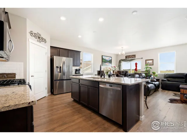 a kitchen with a sink cabinets and wooden floor