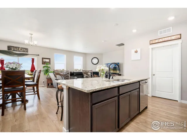 a kitchen with stainless steel appliances kitchen island granite countertop a sink and cabinets
