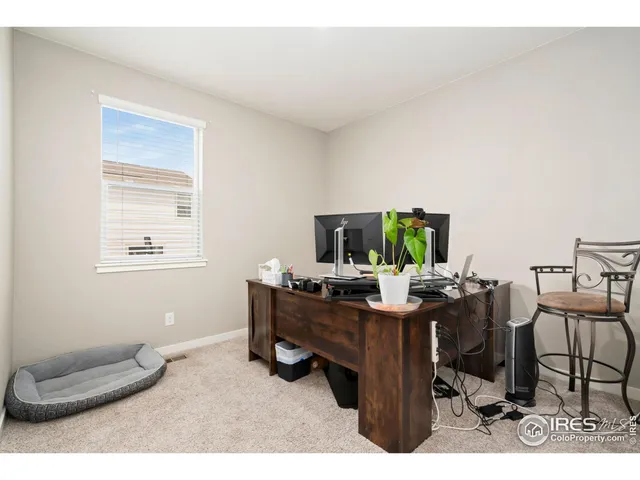 a room with a desk and chair with wooden floor