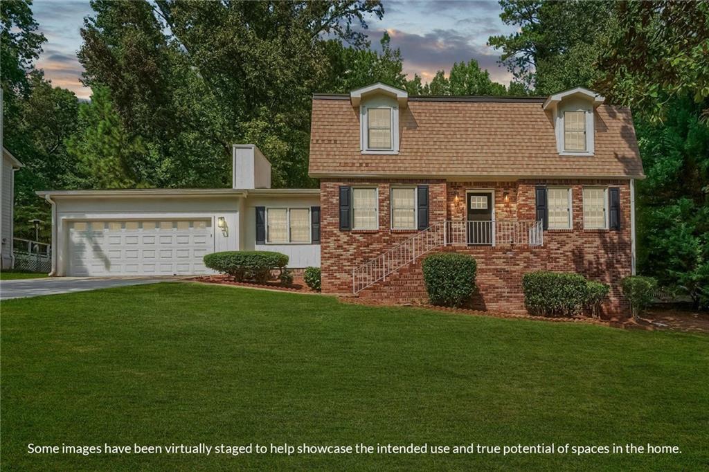 a front view of a house with a garden