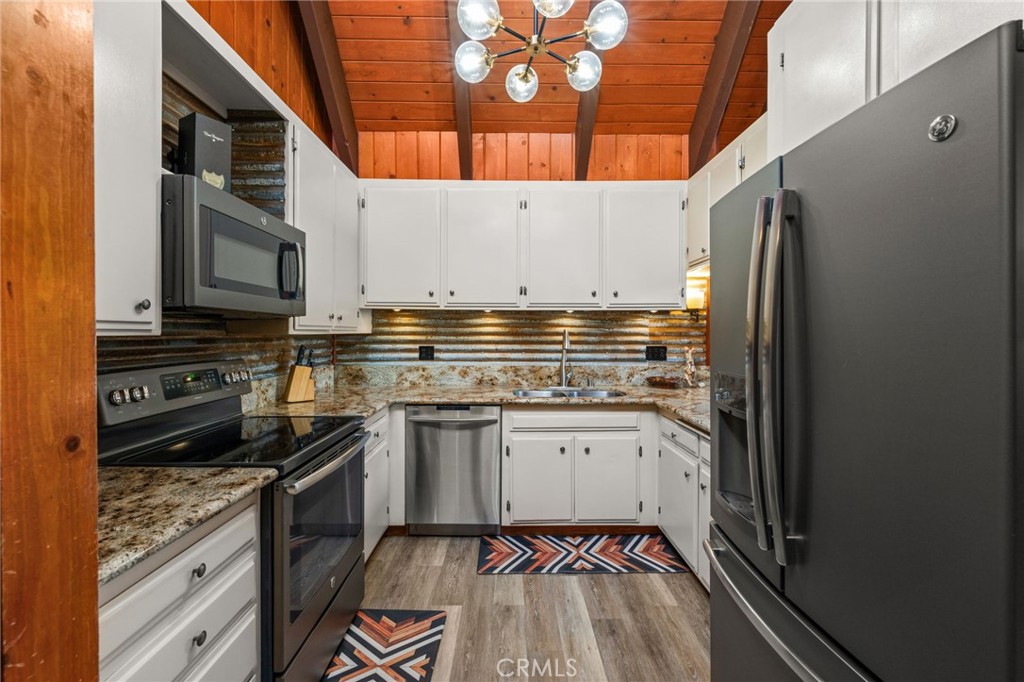 26834 Huron Road Lake Arrowhead, CA 92352 - Photo 9 of 38 a kitchen with stainless steel appliances a stove a sink and a refrigerator
