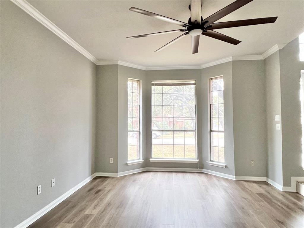 1809 Springwater Drive Round Rock, TX 78681 - Photo 3 of 25 Spare room featuring a ceiling fan, light wood-style flooring, and ornamental molding