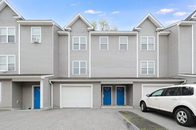 a view of a car park in front of house