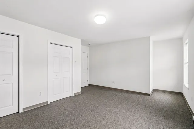 a view of kitchen with stainless steel appliances granite countertop cabinets and window