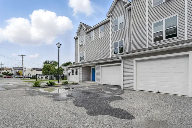 a front view of a building with garage