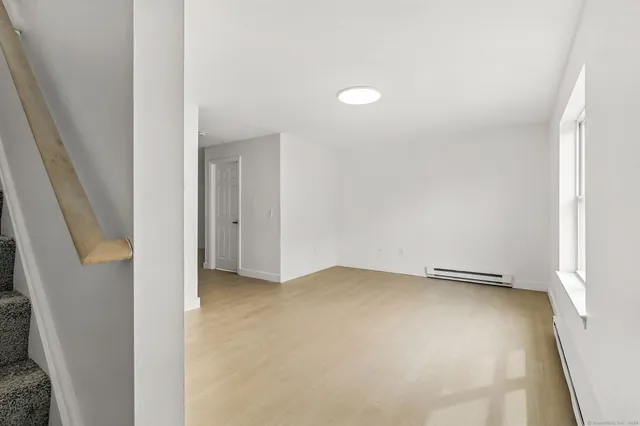 an empty room with an entrance to other room