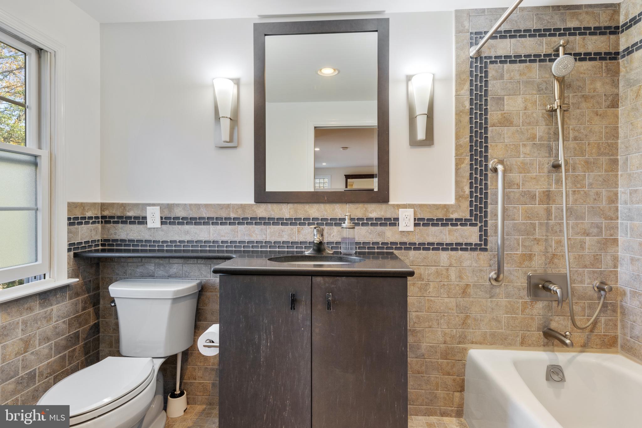 235 Chamounix Road Wayne, PA 19087 - Photo 22 of 32 a bathroom with a granite countertop sink a toilet and shower