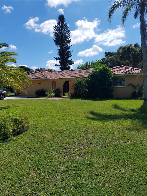 2908 Post Road Sarasota, FL 34231 - Photo 1 of 1 a view of a fountain in front of a house with a big yard