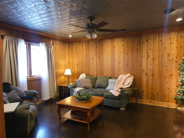 a living room with furniture and a chandelier