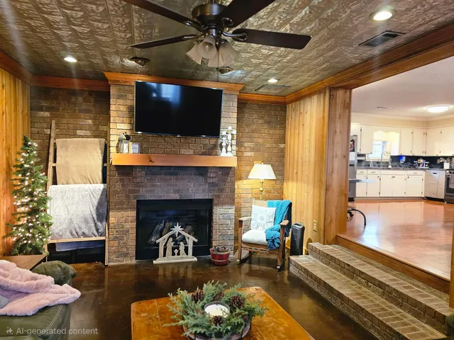 a living room with furniture a flat screen tv and a fireplace