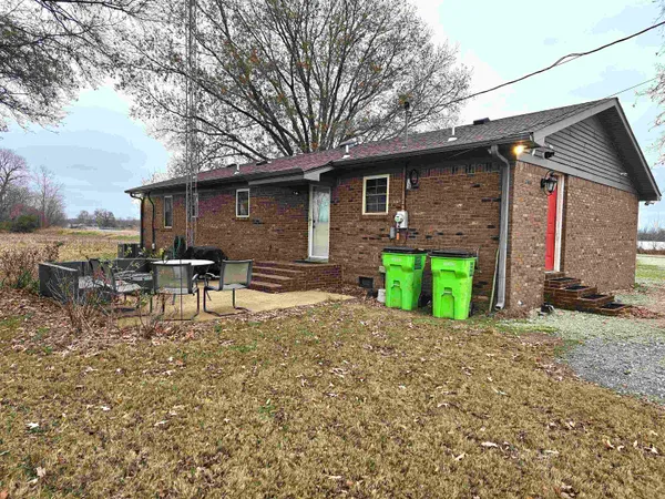 a backyard of a house with yard and outdoor seating