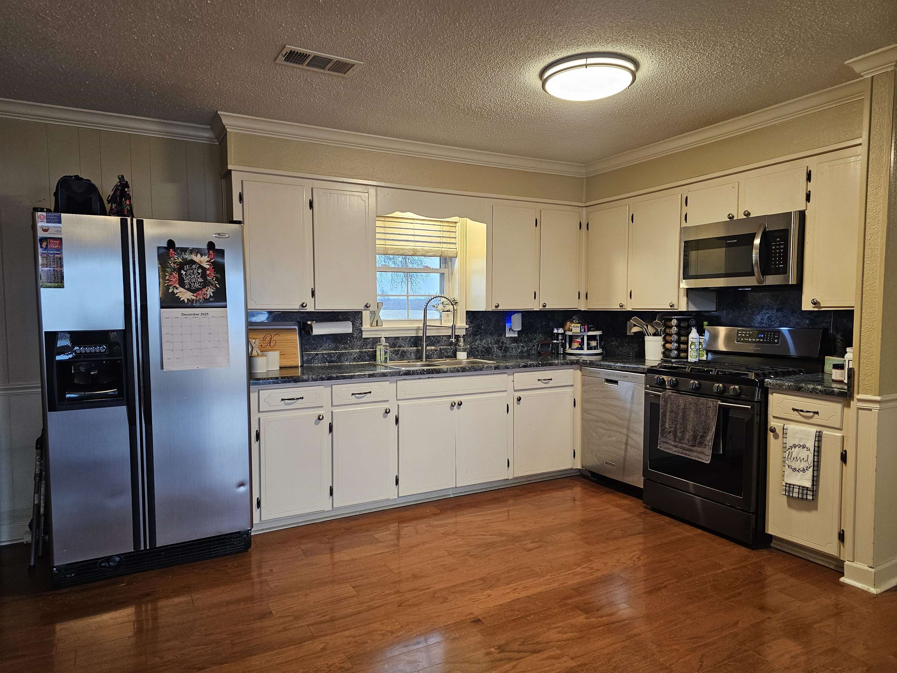 3920 Antioch Highway 51 Road Covington, TN 38019 - Photo 7 of 25 a kitchen with stainless steel appliances granite countertop a refrigerator a stove a sink and a microwave