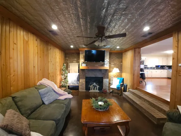 a living room with furniture fireplace and a flat screen tv