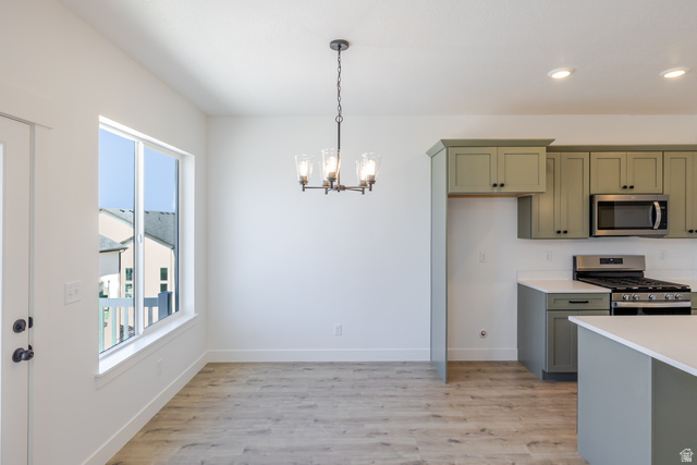 4752 Heartwood Road, Unit 433 Mapleton, UT 84664 - Photo 6 of 20 Kitchen with stainless steel appliances, light wood-type flooring, and a chandelier