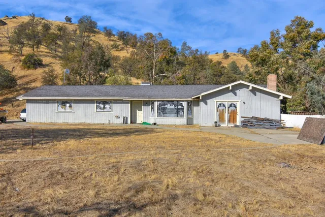 a view of house with outdoor space and sitting area