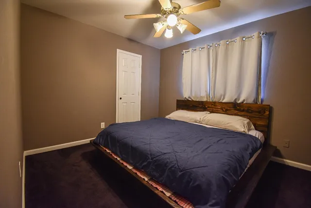 a bedroom with a bed and a window