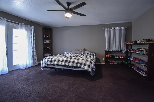 a bedroom with a bed and a chandelier