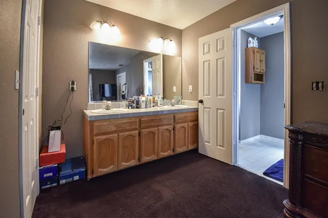 a bathroom with a sink double vanity and a mirror