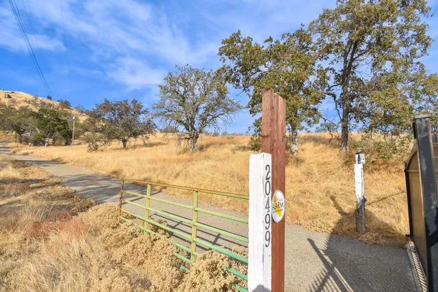 a view of a yard with wooden fence