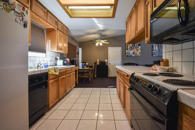 a kitchen with a stove a sink and a refrigerator
