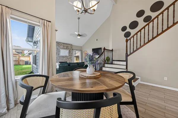 a view of a dining room with furniture and a window