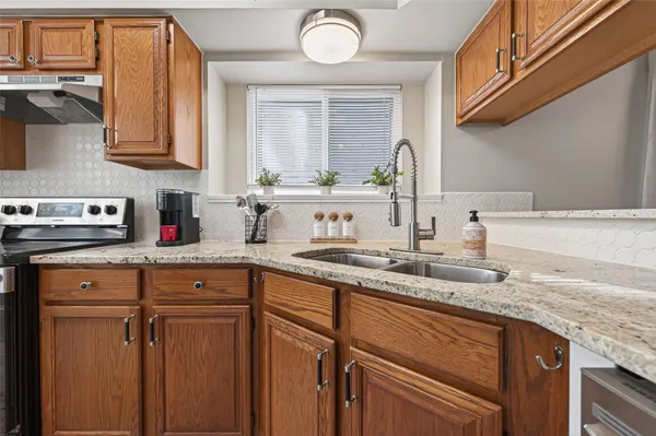 a kitchen with stainless steel appliances granite countertop a sink and cabinets