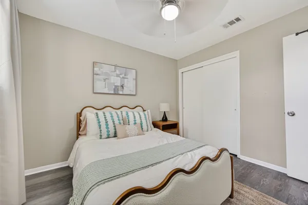 a bedroom with a bed and a painting on the wall