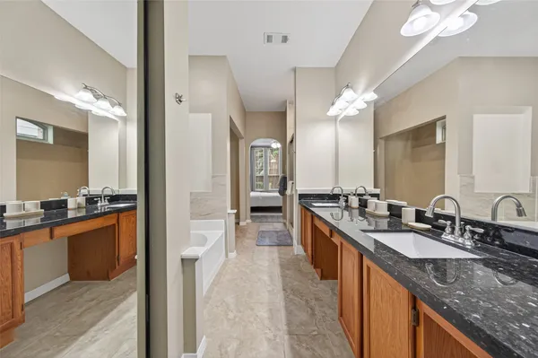 a large kitchen with stainless steel appliances granite countertop a sink and cabinets