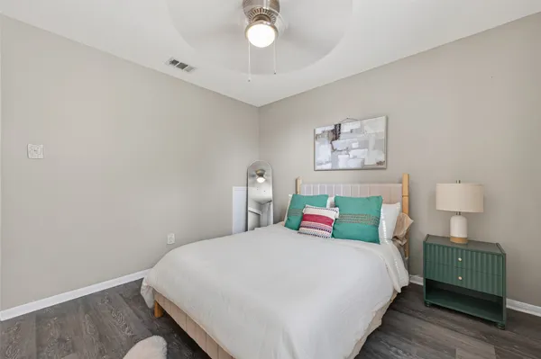 a bedroom with a bed and a painting on the wall