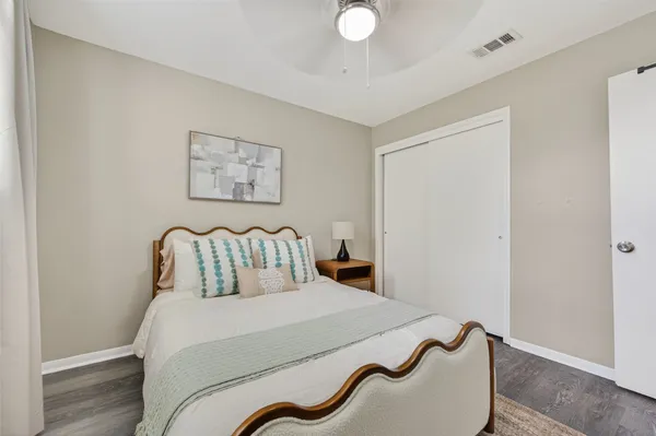 a bedroom with a bed and a painting on the wall