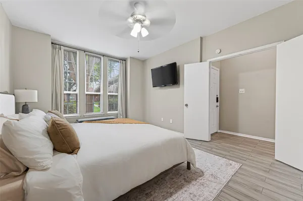 a bedroom with a large bed and a window