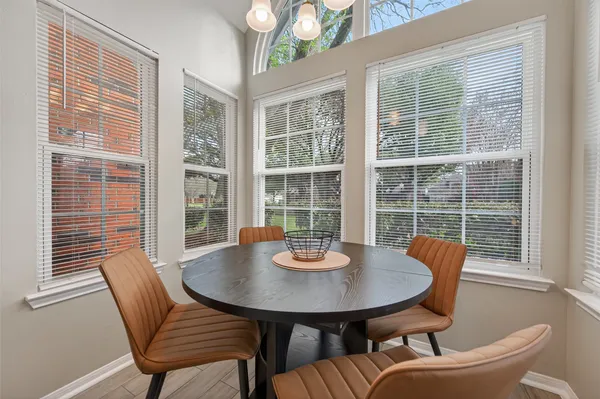 a view of a dining room with furniture and window