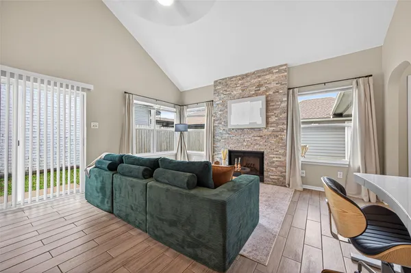 a living room with furniture and a fireplace