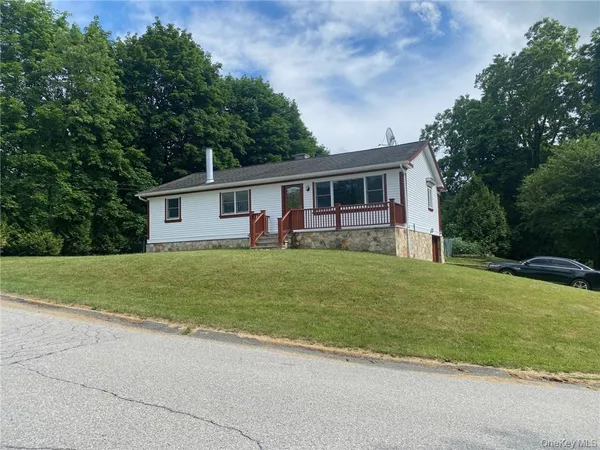 a front view of house with yard and green space
