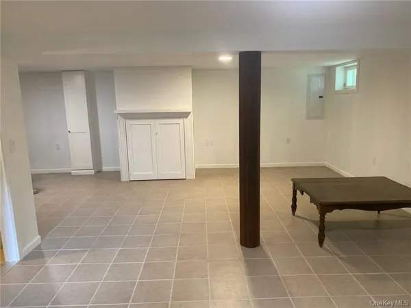 a view of a livingroom with furniture and a window