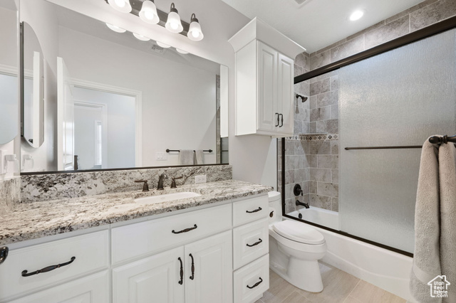 230 Boulder Way Leeds, UT 84746 - Photo 27 of 72 Full bath with vanity and shower / bath combination with sliding glass shower doors, granite countertops and soft-close cabinetry and tile flooring.