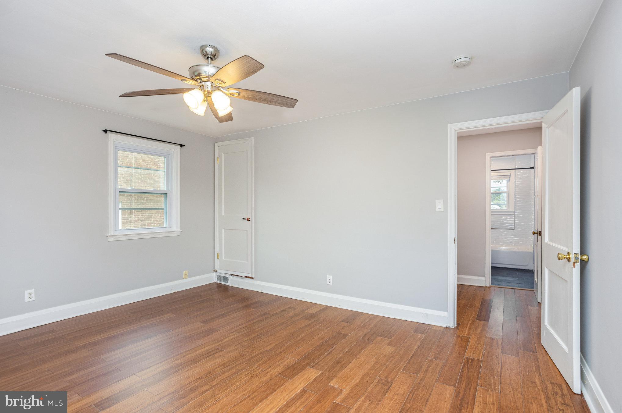 6309 Clearspring Road Baltimore, MD 21212 - Photo 10 of 18 a view of an empty room with wooden floor and a window