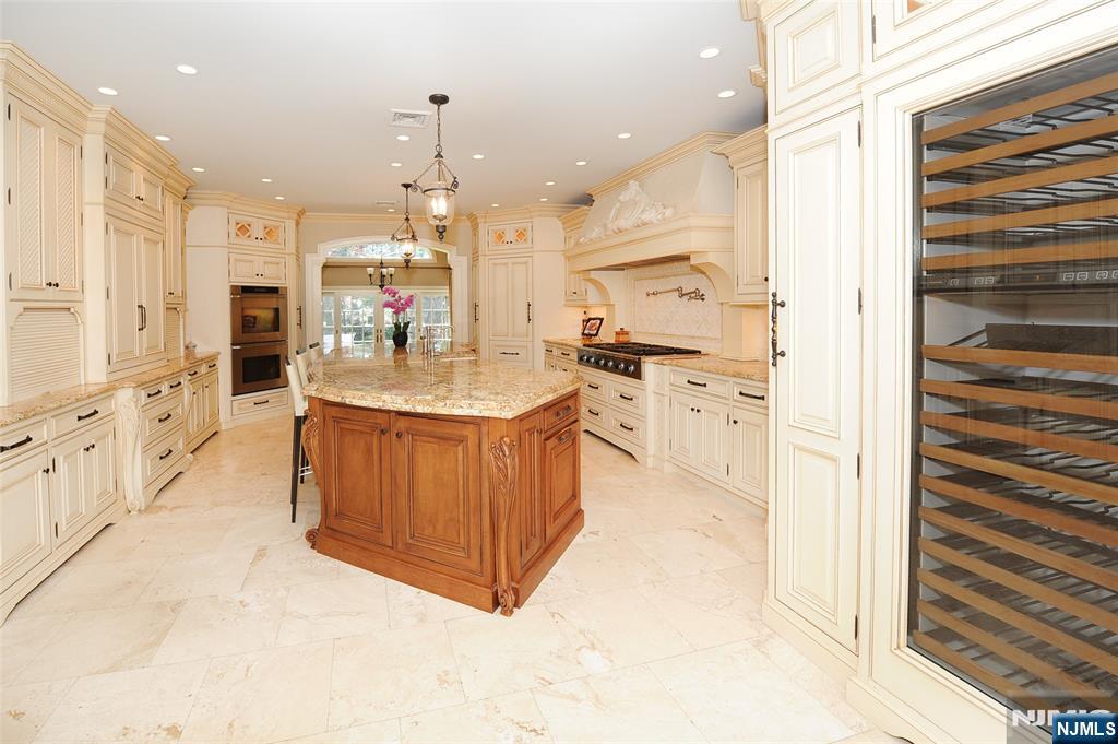 273 Joshua Lane Wyckoff, NJ 07481 - Photo 12 of 17 a large kitchen with stainless steel appliances a stove a sink dishwasher and a refrigerator with wooden floor