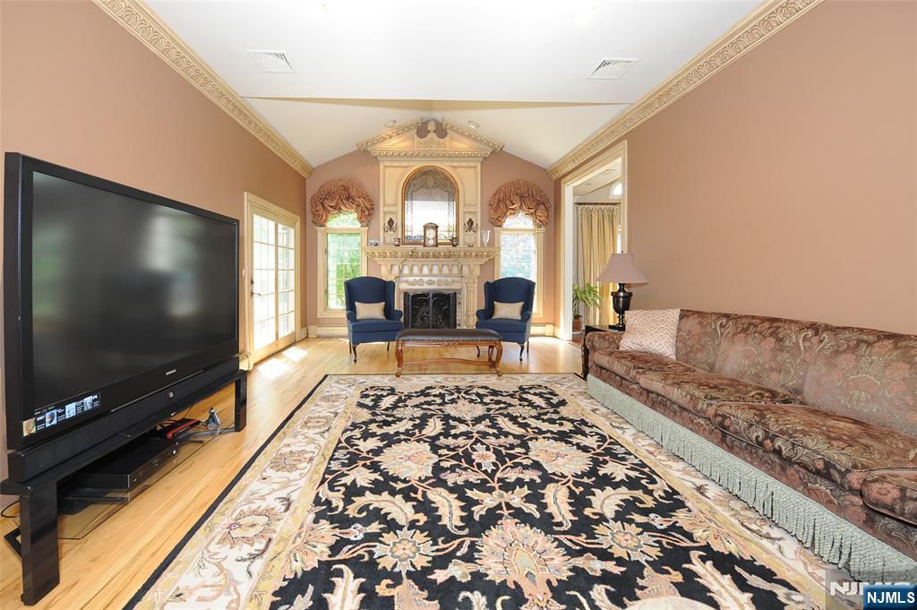 273 Joshua Lane Wyckoff, NJ 07481 - Photo 10 of 17 a living room with a flat screen tv and a floor to ceiling window