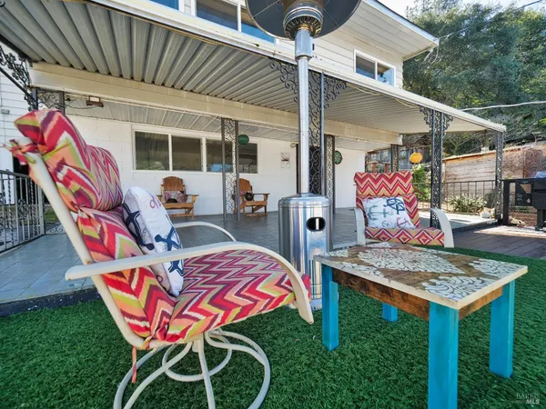 a view of a porch with furniture and wooden floor