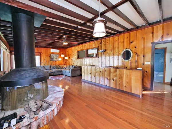 a bedroom with a bed and a lamp on dresser